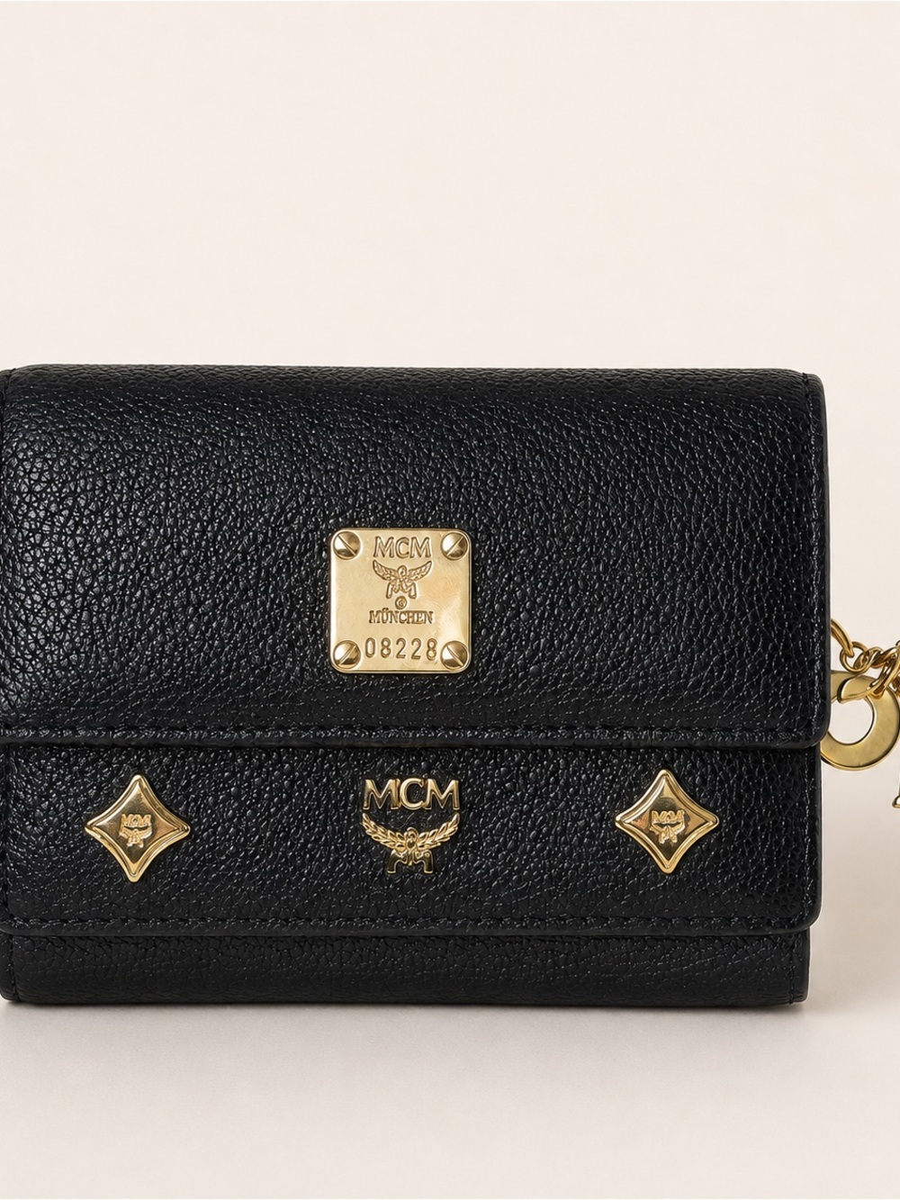 MCM Black Pebbled Leather Trifold Wallet Gold Logo Charms